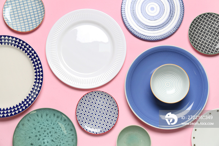 Composition with stylish ceramic plates on pink background