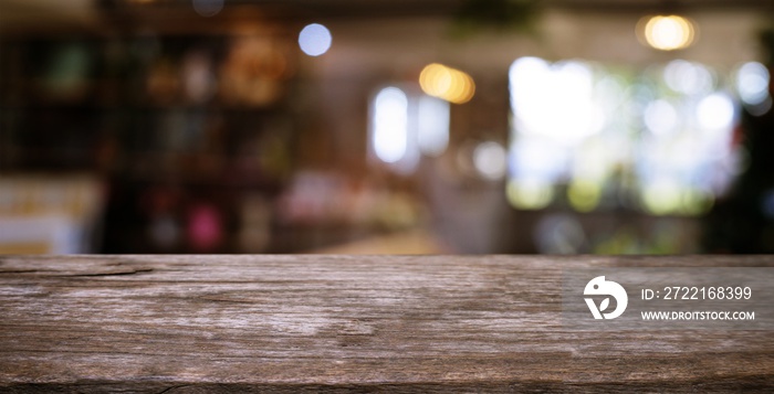 Empty wooden table in front of abstract blurred background of coffee shop . can be used for display 