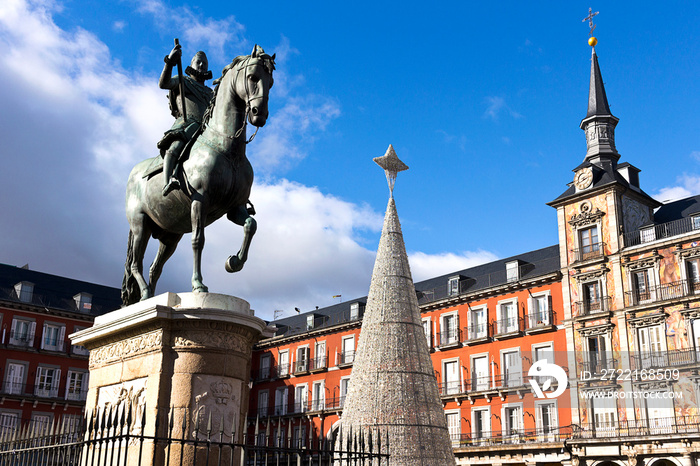 Madrid - Plaza Mayor, bronze statue of King Philip III, Christmas tree and painting facade.