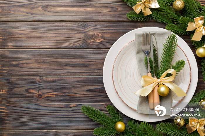 Christmas table place setting with christmas decor and plates, kine, fork and spoon. Christmas holid