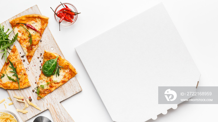 Pizza slices on cutting board and empty cardboard box