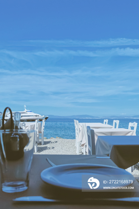 Empty restaurant by the Aegean sea and cruise boat, travel and nature, scene