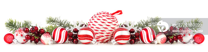 Christmas border of red and white ornaments and branches. Side view isolated on a white background.