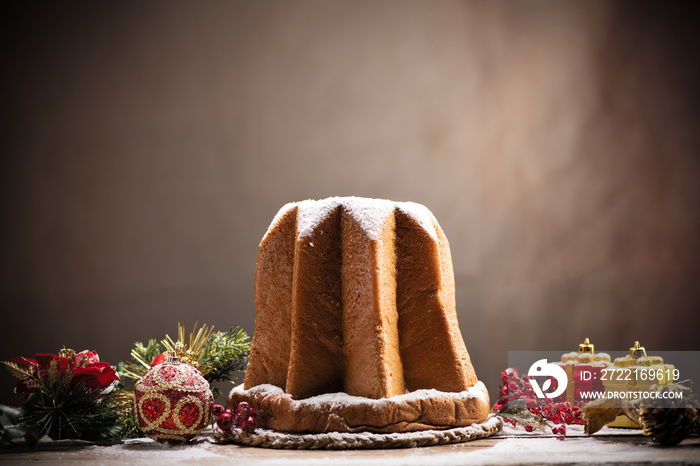 Traditional Italian Christmas cake Pandoro with christmas decoration and gifts.