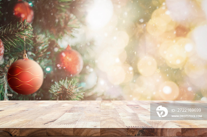 Wooden table with space with Christmas tree and blurred light bokeh for mock up or montage your prod