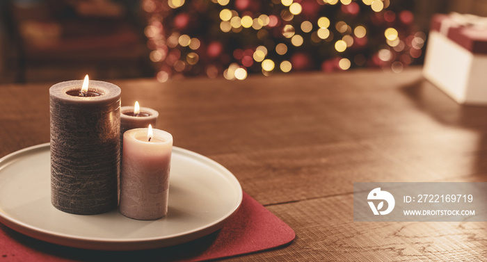 Candles and Christmas tree bokeh lights