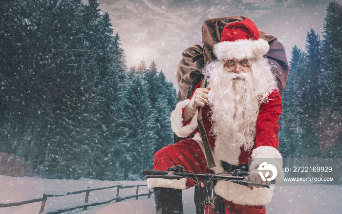 Santa riding a bicycle and carrying gifts