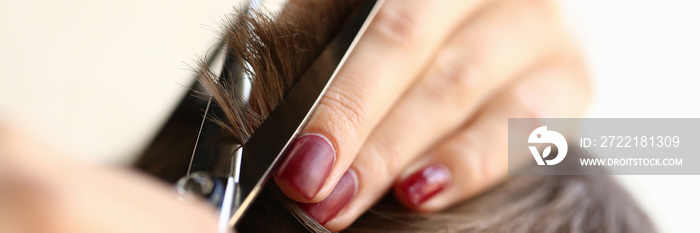 Female Fingers Trimming Male Hair by Scissors