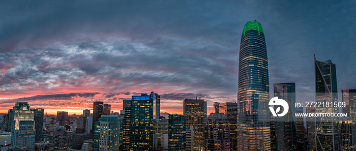 Beautiful orange, yellow and red sunset over the San Francisco skyline with a green tip on the tallest building