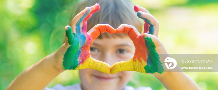 child with painted hands and legs. Selective focus.