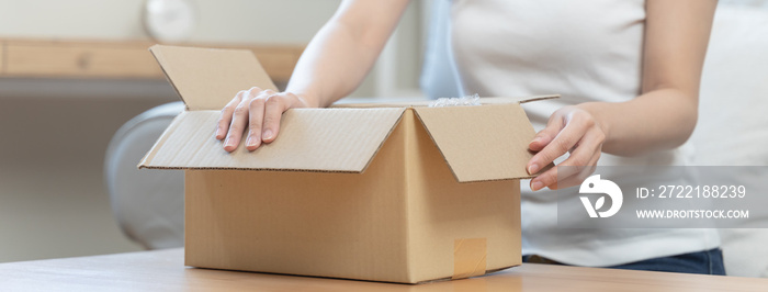 person unboxing package shopping online via internet at home