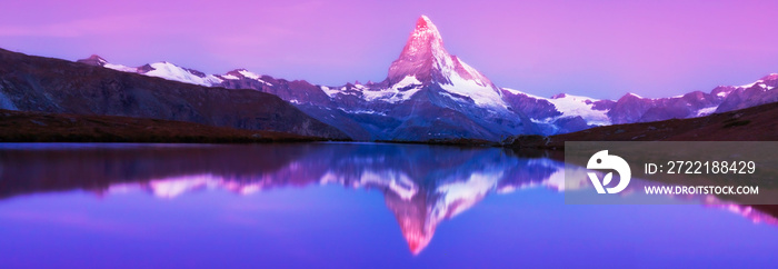 Beautiful sunset colors and cloudscape in the Swiss Alps in summer, with Matterhorn reflection in a glacier lake