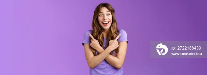 Lively surprised charismatic curly girl fascinated look admiration joy picking between awesome opportunities amazed excellent choices pointing sideways left right make decision purple background