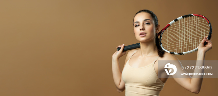 Website header of Charming young woman with tennis racket posing in studio