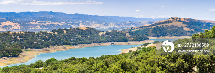 High angle view of Anderson Reservoir, a man made lake in Morgan Hill, managed by the Santa Clara Valley Water District, maintained at low level due to failure risk in case of earthquake; California