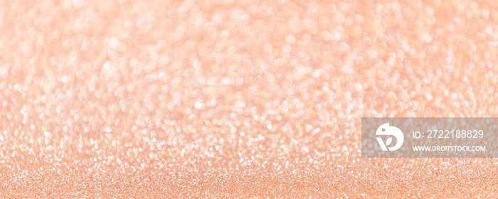 Abstract blurred coral or peach magic glitter banner with copy space.