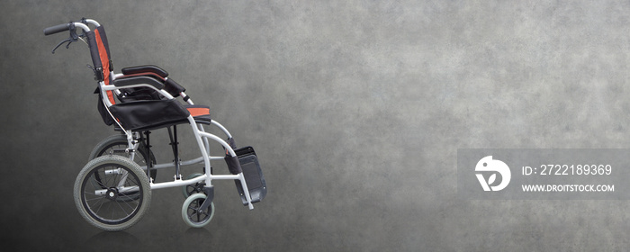 Side view Di cut black and orange Wheel chair on gray background, object, copy space