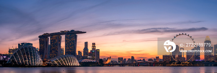 Panoramic view of Singapore skyscrapers at dusk.