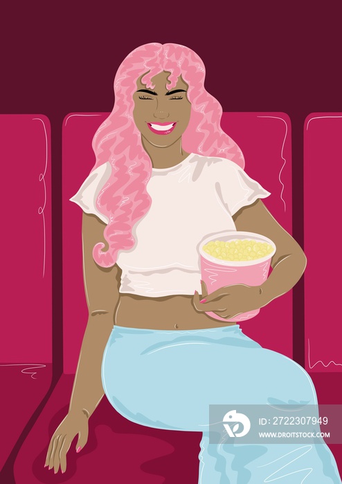 Girl sitting in cinema with popcorn