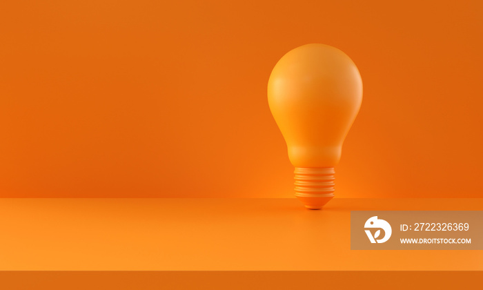 Light bulb on orange background. Horizontal composition with copy space. Creativity and innovation i