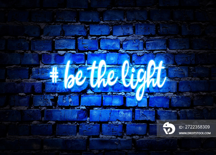 Be the light. Shining neon hashtag on blue brick wall background. Positive message