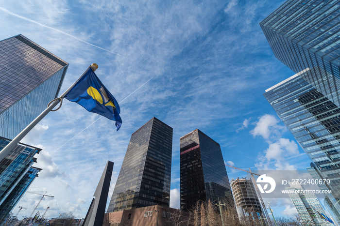 Brussels, Belgium -  The contemporary North Galaxy tower with the Federal government offices and a Belgian and European flag in the business Little Manhattan district