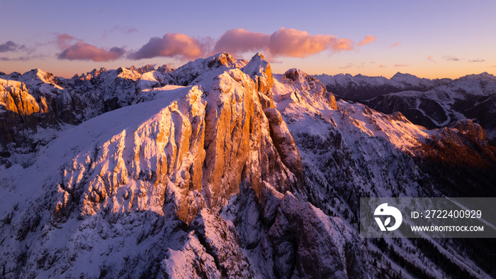 sunset in the mountains covered by snow