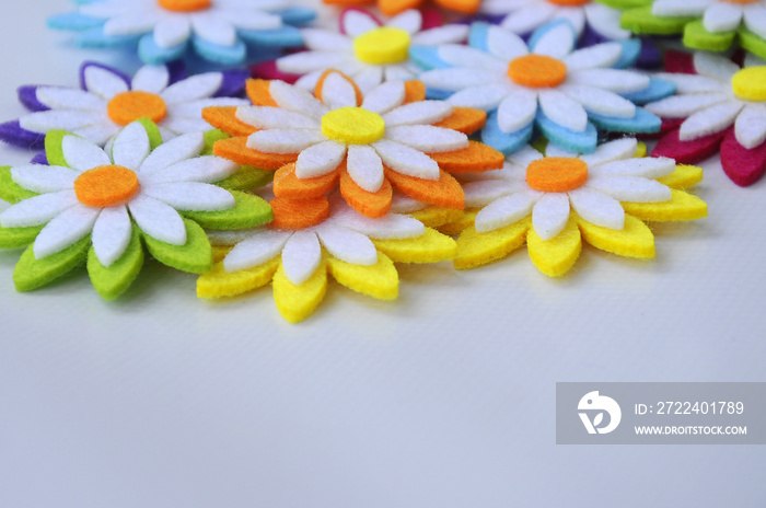 Images of flowers made of colorful felt fabrics. Isolated on white background.