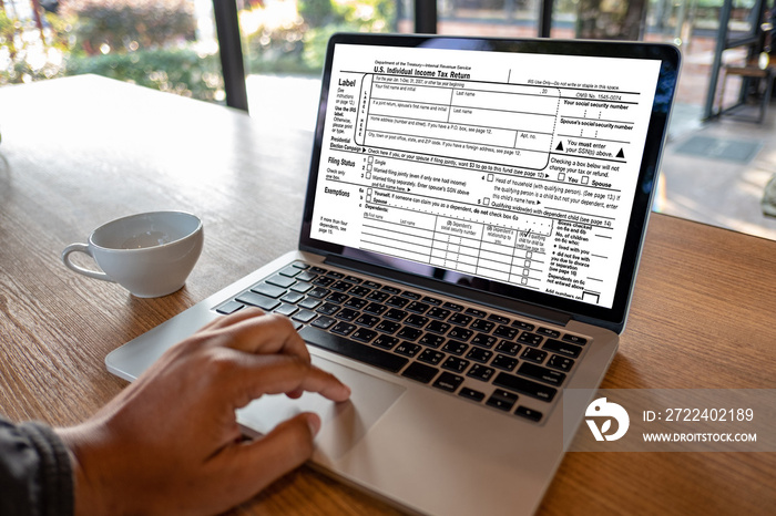 time to tax using calculator and laptop for calaulating finance tax season concept