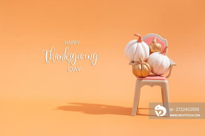 Thanksgiving message with collection of autumn pumpkins on toy chair.