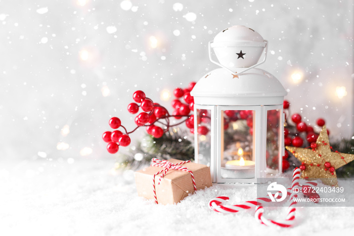 White lantern and red decorations on snow