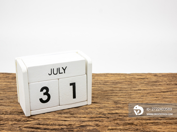 July 31 white cube wooden calendar on vintage wood and white background with summer day, Copyspace for text