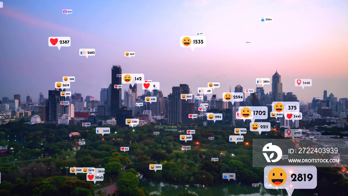 Social media icons fly over city downtown showing people reciprocity connection through social network application platform . Concept for online community and social media marketing strategy .