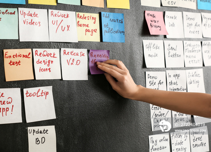 Young woman near scrum task board in office