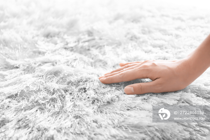 Woman touching carpet, closeup