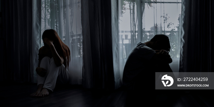 Sad young man and woman sitting on the bed in the bedroom, People with depression concept.