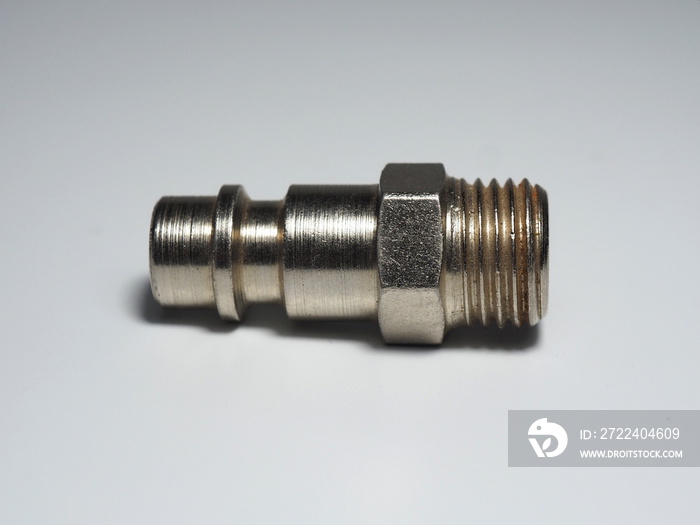 Air nipple on most pneumatic tools of small and medium sizes. Plugin nipple on white background. Metal high pressure hose fitting quick coupling connect for air.