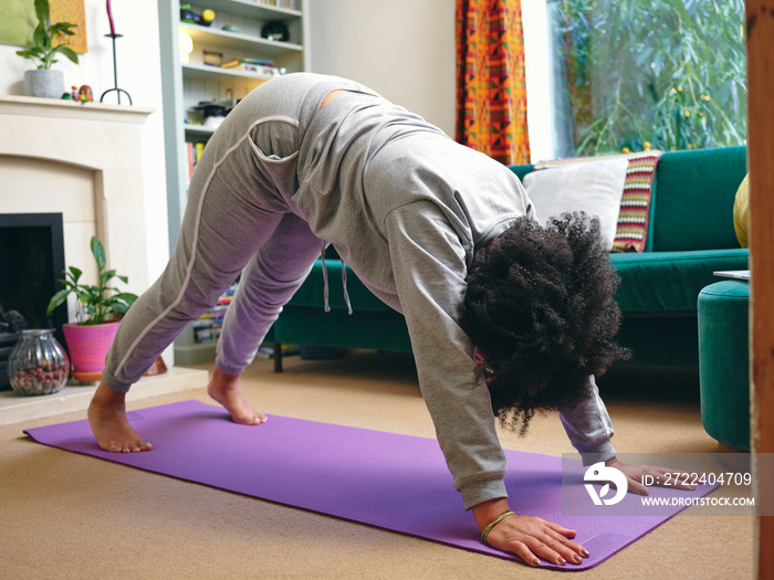 Woman practicing yoga at home