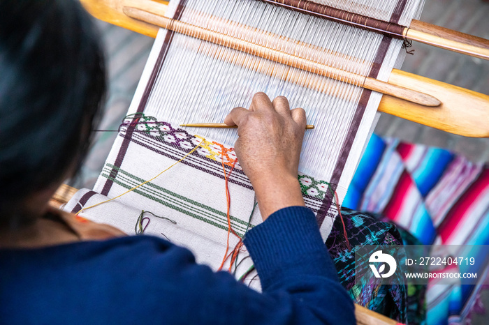 woman weaving a scarf