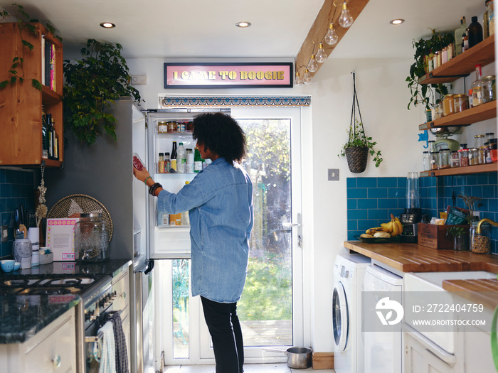 Woman opening fridge