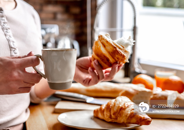 Coffee cup and croissants at kitchen table