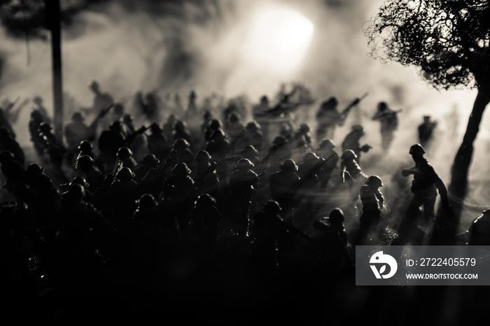 War Concept. Military silhouettes fighting scene on war fog sky background, World War Soldiers Silhouette Below Cloudy Skyline At night.