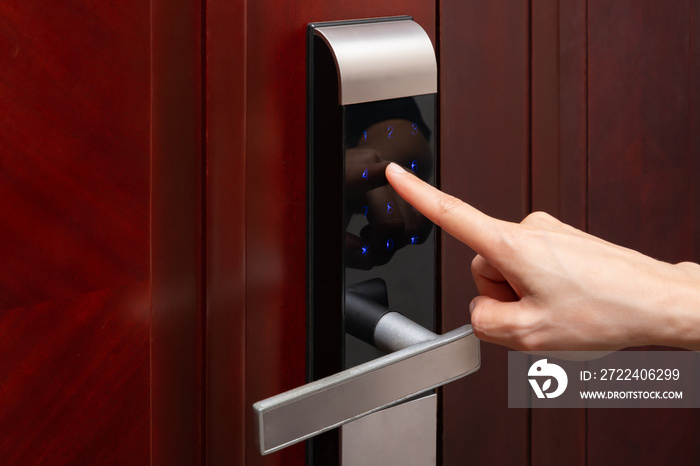 lady inputing passwords on an electronic door lock