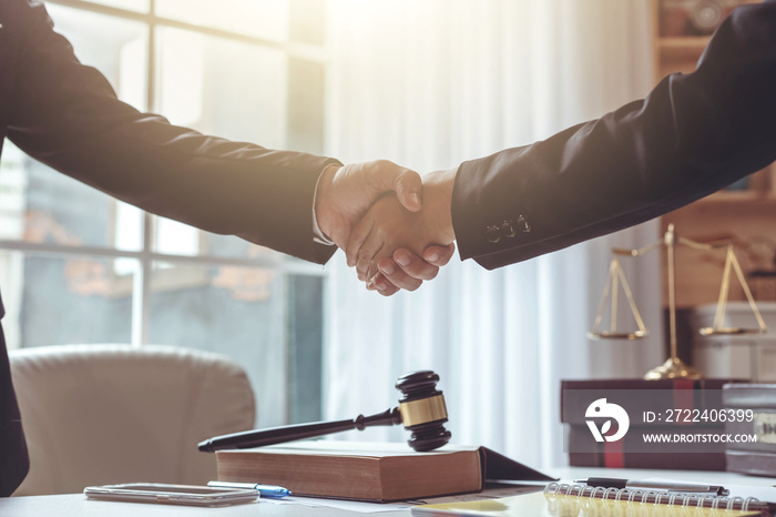 Businessman and lawyer shaking hands.