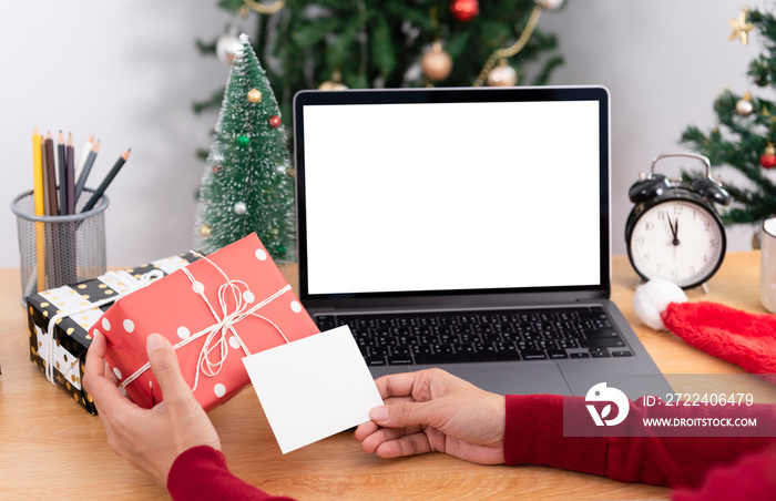 business woman holding giftbox and greeting card on office table in Christmas day.