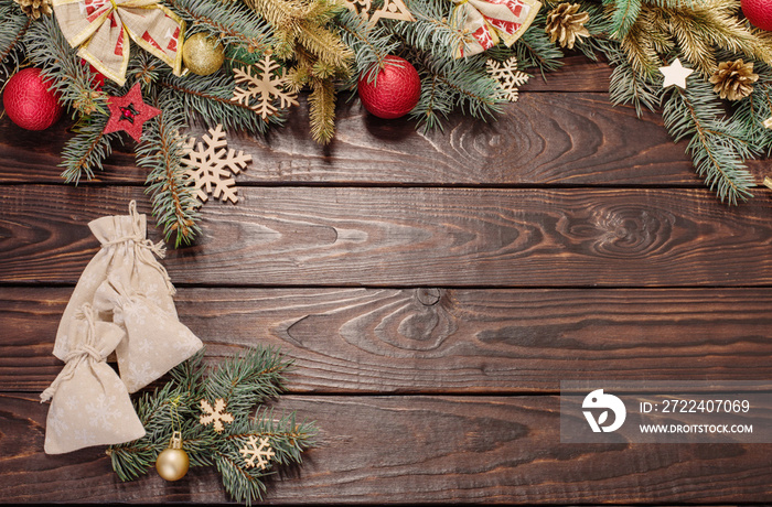 fir branches with Christmas decor on old dark wooden background