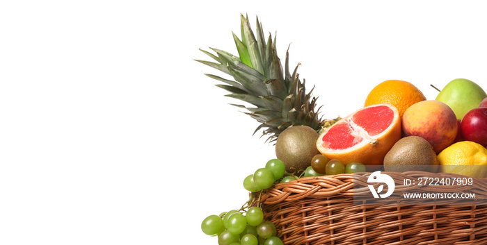 Basket with fresh fruits on white background with space for text