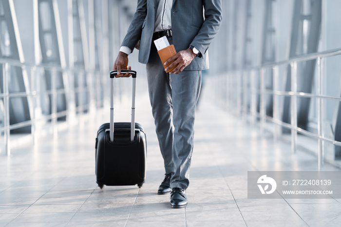 Businessman Moving To Departure Gate holding Tickets