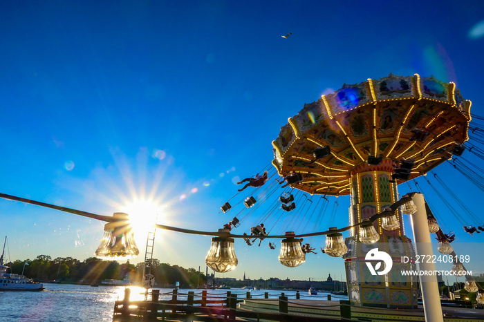 Stockholm, Sweden People enjoying the swings at the amusement park called Gröna Lund.