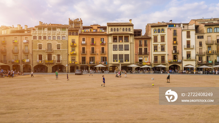 Vic Catalonia Spain Placa Major Main Square . Golden light. Summer time. People walking streets. Street life photo